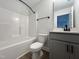 Modern bathroom featuring a shower-tub combo, toilet, and a vanity with neutral-colored cabinets at 152 S Mistflower St, Clayton, NC 27520