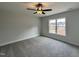 Serene bedroom with neutral walls, plush carpeting, a ceiling fan, and a bright window view at 152 S Mistflower St, Clayton, NC 27520