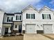 Charming townhomes with white siding, black shutters, and attached garages offer modern living at 152 S Mistflower St, Clayton, NC 27520