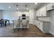 Modern kitchen featuring white cabinets, granite countertops, and an island with seating at 152 S Mistflower St, Clayton, NC 27520
