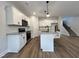 Spacious kitchen with white cabinets, granite countertops, island seating, and stainless steel appliances at 152 S Mistflower St, Clayton, NC 27520