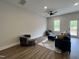 Inviting living room with modern furnishings, a ceiling fan, and natural light at 152 S Mistflower St, Clayton, NC 27520