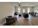 Open concept living area with modern seating, dining space, and abundant natural light at 152 S Mistflower St, Clayton, NC 27520
