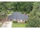 Aerial view of the brick home featuring mature trees and in-ground swimming pool at 184 Pine E St, Lillington, NC 27546