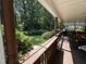 Rear covered porch looking out on green lawn and mature trees at 184 Pine E St, Lillington, NC 27546