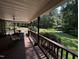 Enjoy serene outdoor living on this covered back porch with views of the landscaped yard at 184 Pine E St, Lillington, NC 27546