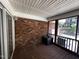 Screened-in porch features brick wall and view of wooded yard at 184 Pine E St, Lillington, NC 27546
