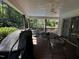 Inviting porch with ceiling fan overlooking backyard pool and lush landscape at 184 Pine E St, Lillington, NC 27546