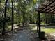 View of a large lot with a canopy near a wooded area and gravel driveway at 184 Pine E St, Lillington, NC 27546