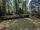Expansive backyard with lush greenery and azaleas and a covered patio creates a private outdoor space at 184 Pine E St, Lillington, NC 27546