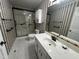 The bathroom has a vanity, commode, and walk-in shower with a black and white design at 184 Pine E St, Lillington, NC 27546