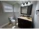 Well-lit bathroom featuring a dark wood vanity, tile flooring and framed mirror at 184 Pine E St, Lillington, NC 27546