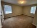 This bedroom features neutral carpet, and two windows offering natural light at 184 Pine E St, Lillington, NC 27546