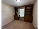 Bedroom features built-in cabinets, a window desk, and neutral carpet at 184 Pine E St, Lillington, NC 27546