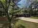 Charming brick home featuring a well-maintained lawn, mature dogwood, and a paved driveway at 184 Pine E St, Lillington, NC 27546
