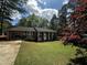 Traditional brick home featuring a manicured lawn, classic white columns, and an attached garage at 184 Pine E St, Lillington, NC 27546