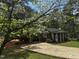Charming brick home featuring a well-manicured lawn and driveway framed by a beautiful dogwood tree at 184 Pine E St, Lillington, NC 27546