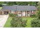 Charming brick home with well-manicured lawn, mature trees, and attached garage perfect for a suburban lifestyle at 184 Pine E St, Lillington, NC 27546