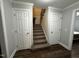 This hallway leads to the staircase and has access to rooms with doors at 184 Pine E St, Lillington, NC 27546