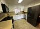 Well-equipped kitchen with modern black appliances and white cabinetry at 184 Pine E St, Lillington, NC 27546