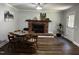 Bright living room with hardwood floors, white trim, and a brick fireplace at 184 Pine E St, Lillington, NC 27546