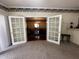 View from the living room looking into the dining room, separated by glass doors at 184 Pine E St, Lillington, NC 27546