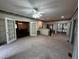 Expansive living room featuring carpet, a ceiling fan, and doors to the patio at 184 Pine E St, Lillington, NC 27546