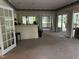Spacious living room with neutral carpet and bar area with access to the outdoor deck at 184 Pine E St, Lillington, NC 27546