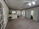 Open living room with bar area and sliding glass doors accessing the outdoor balcony at 184 Pine E St, Lillington, NC 27546