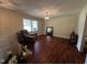 Living room with hardwood floors and a view of the staircase to the upper level at 184 Pine E St, Lillington, NC 27546