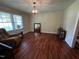 Living room with hardwood floors, a large window, and a comfortable recliner at 184 Pine E St, Lillington, NC 27546