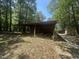 Open storage building in a wooded lot; great for storing lawn equipment and gardening supplies at 184 Pine E St, Lillington, NC 27546