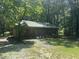 Charming outbuilding surrounded by trees and greenery in a peaceful setting at 184 Pine E St, Lillington, NC 27546