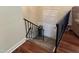 Carpeted staircase with metal railing leads to an upper level with a door at 184 Pine E St, Lillington, NC 27546
