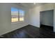 Bedroom with a large window, dark hardwood floors, and neutral-colored walls at 175 W Saltgrass Ln, Smithfield, NC 27577