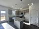 Bright, modern kitchen with granite countertops, stainless appliances, and gray cabinets at 175 W Saltgrass Ln, Smithfield, NC 27577