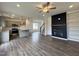 Open-concept living area with a kitchen, fireplace, and hardwood floors at 175 W Saltgrass Ln, Smithfield, NC 27577