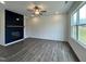 Bright living room with a fireplace, built-in shelving, and large windows at 175 W Saltgrass Ln, Smithfield, NC 27577