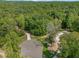 An aerial view of a lot with a driveway and surrounded by a mature forest at 222 Kenwood Ln, Pittsboro, NC 27312