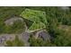 Aerial view showcasing the boundaries of a wooded lot with lush greenery and surrounding mature trees at 222 Kenwood Ln, Pittsboro, NC 27312