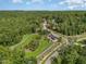 Expansive aerial view of a home site with a luxurious outdoor living space surrounded by lush greenery at 222 Kenwood Ln, Pittsboro, NC 27312