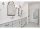 A bathroom with double vanity, black and white floor tile and decorative lighting at 222 Kenwood Ln, Pittsboro, NC 27312