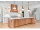 Elegant kitchen with custom cabinetry, large island, brass accents, and hardwood floors at 222 Kenwood Ln, Pittsboro, NC 27312