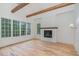 This living room features exposed wood beams, hardwood floors and a gas fireplace at 222 Kenwood Ln, Pittsboro, NC 27312