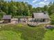 Aerial view showcasing outdoor entertaining area with fireplace, multiple seating areas, and manicured landscaping at 222 Kenwood Ln, Pittsboro, NC 27312