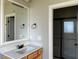 Bathroom boasts a pristine sink and vanity, with mirror and a glass door shower at 941 Olive Branch Dr, Smithfield, NC 27577