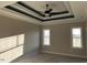 The bedroom has natural lighting, complemented by stylish trey ceilings and a fan at 941 Olive Branch Dr, Smithfield, NC 27577