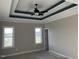 Comfortable bedroom boasting double windows for ample natural light and modern tray ceilings at 941 Olive Branch Dr, Smithfield, NC 27577