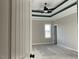 A bedroom showcases modern tray ceilings, a ceiling fan and a bright window at 941 Olive Branch Dr, Smithfield, NC 27577