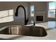 Kitchen sink with a large window, modern faucet and stone countertops and backsplash at 941 Olive Branch Dr, Smithfield, NC 27577